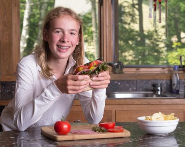 Hungry Teenager with large sandwich