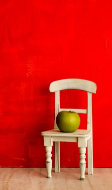 Still life with small chair and apple