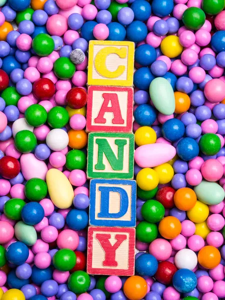 Candy spelled out in alphabet blocks — Stock Photo, Image