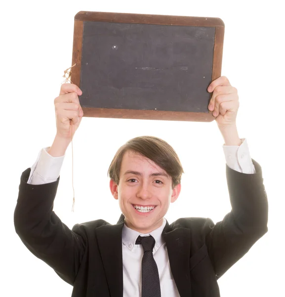 Teen boy in suit and tie holding up a blank chalkboard for custom copy — Stock Photo, Image