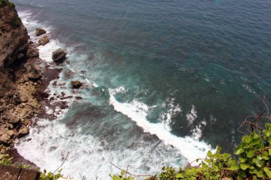 Bali 'deki Uluwatu Tapınağı' nın altında dalga, kaya ve okyanus. Ocak 2022 'de çekildi..