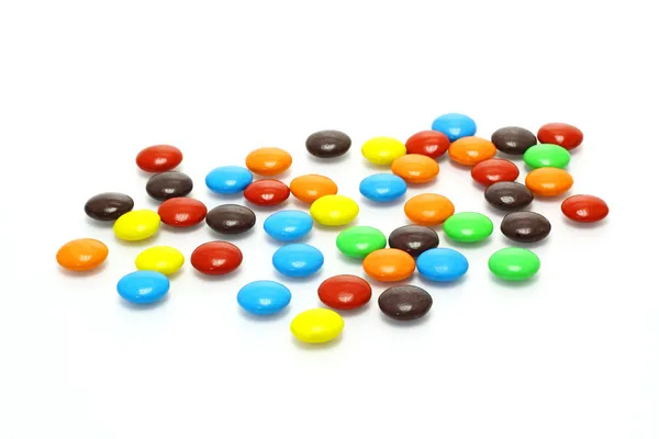 Lots of colorful candies spread on white background — Stock Photo, Image