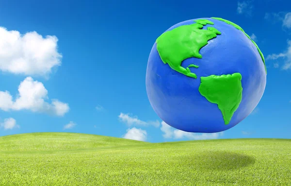 Clay earth over the green grass field eco concept — Stock Photo, Image