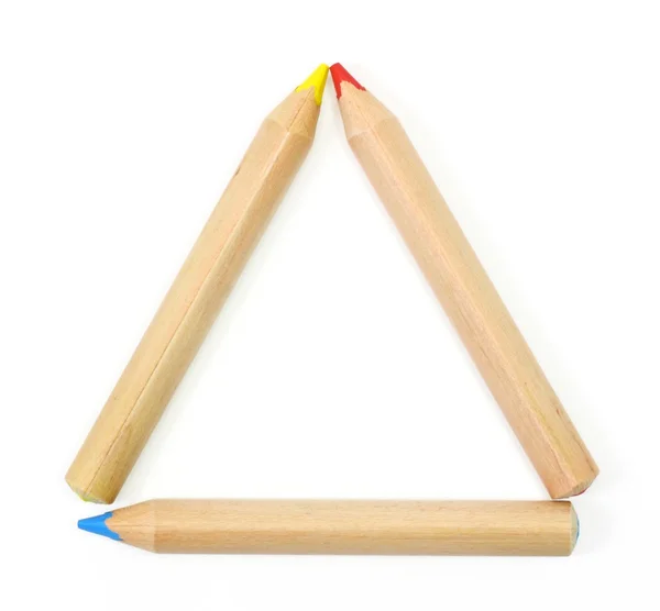 Crayons de couleur sertis comme un cadre triangle sur blanc — Photo