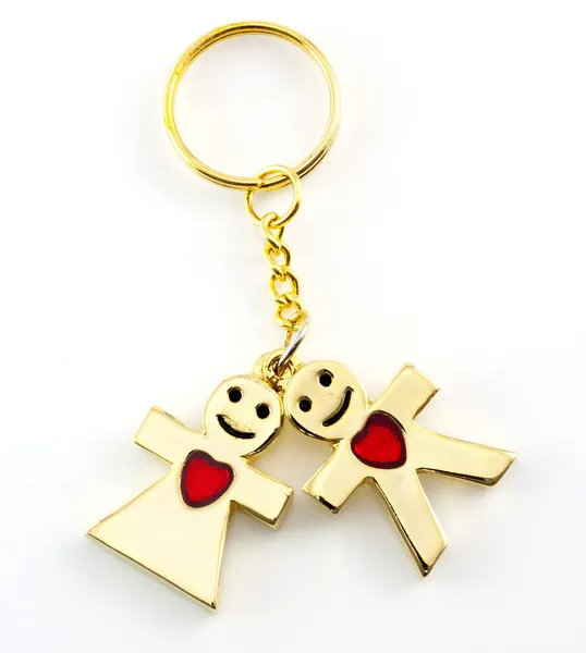 Beautiful golden keychain with man and woman red heart doll iso — Stock Photo, Image