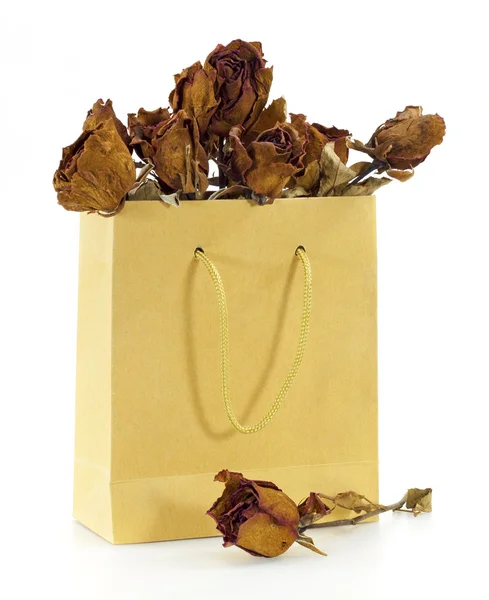 Dried roses in a paper bag — Stock Photo, Image