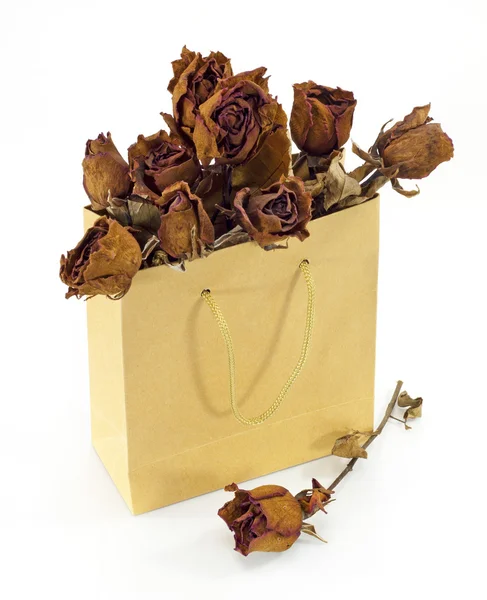 Dried roses in a paper bag — Stock Photo, Image