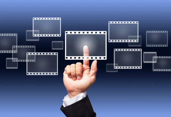 Hand pushing a film button on a touch screen interface — Stock Photo, Image