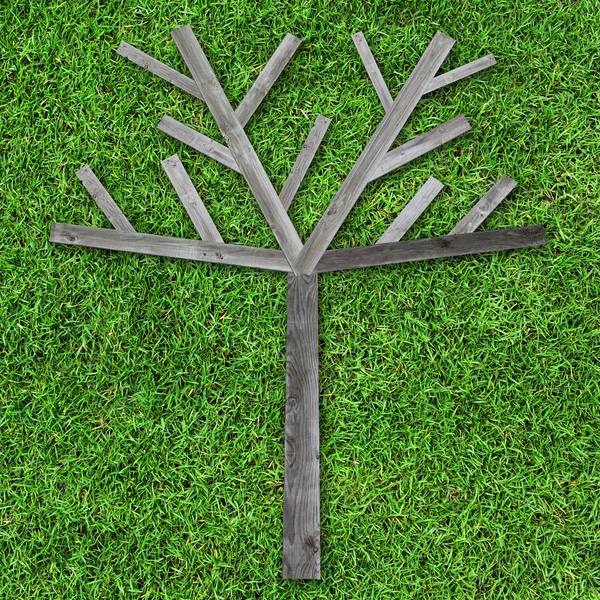 Wooden tree made of wood on green grass for fill object or photo — Stock Photo, Image