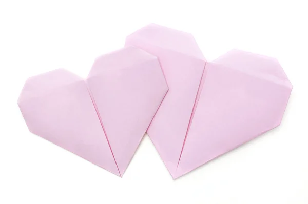 Origami papel corazones rosados en blanco — Foto de Stock