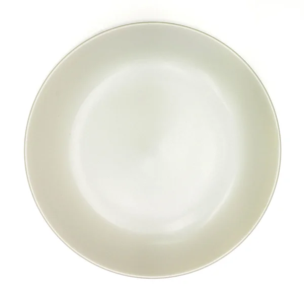 Krém porcelánový talíř na bílém pozadí — Stock fotografie