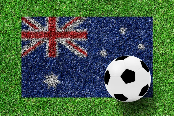 Soccer ball on Australia flag as a painting on green grass — Stock Photo, Image