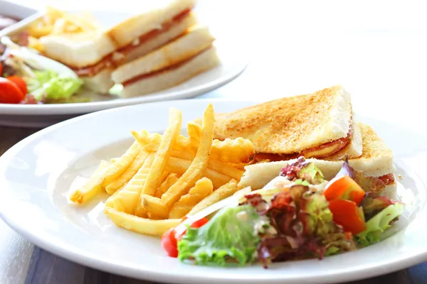 Delicious club sandwich with french fries and salad — Stock Photo, Image