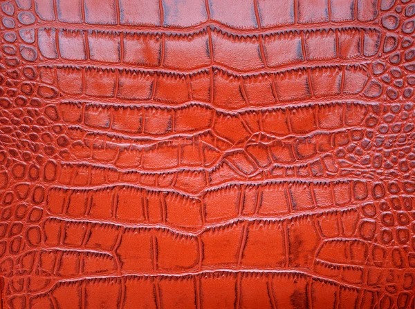 Textura da pele de crocodilo vermelho como um papel de parede — Fotografia de Stock