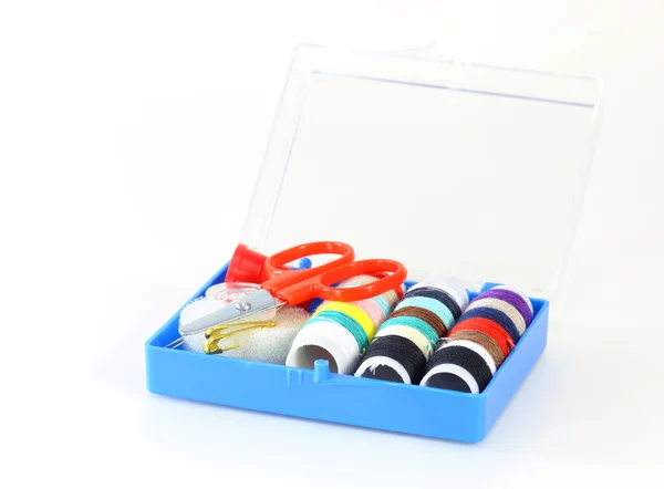 Sewing accessories (threads, pins and needle) on a white backgro — Stock Photo, Image