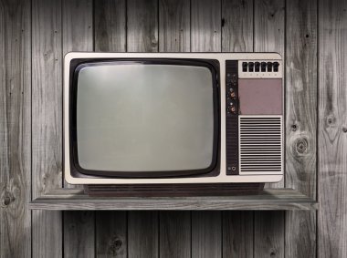 old television on wood shelf background