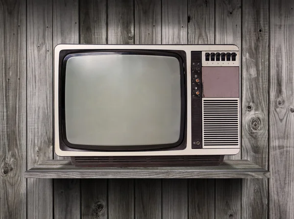 Old television on wood shelf background — Stock Photo, Image