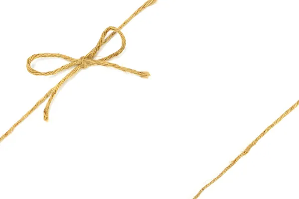 String amarrado em um arco no branco — Fotografia de Stock