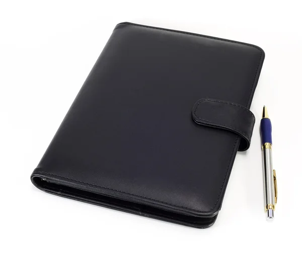 Black note book and pen on white background Stock Picture