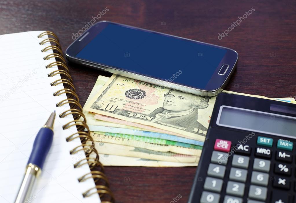 smartphone money business composition on wood table
