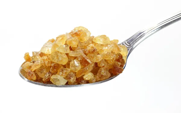 Cane sugar on spoon — Stock Photo, Image