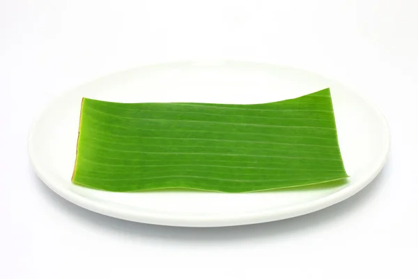 Banana leaf on blank plate for edit food or subject on — Stock Photo, Image