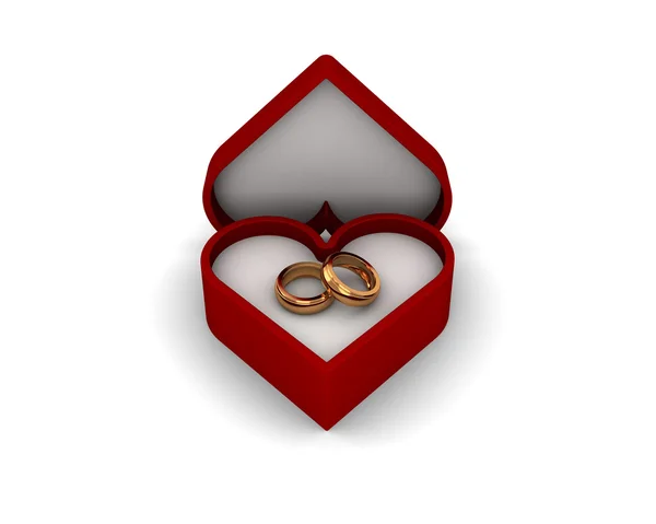 Eleganckie złote obrączki w czerwone pudełko w kształcie serca na białym tle — Zdjęcie stockowe