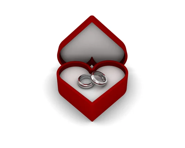 在白色背景上孤立的红色心形盒子的优雅结婚戒指。 免版税图库图片