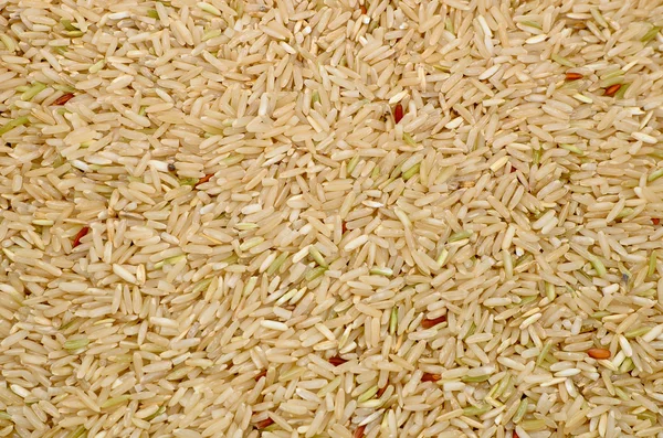Uncooked Brown rice grains food background — Stock Photo, Image
