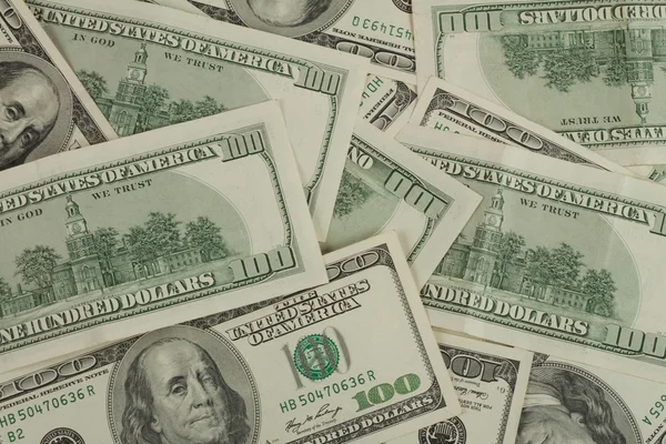 Background with randomly scattered dollars — Stock Photo, Image