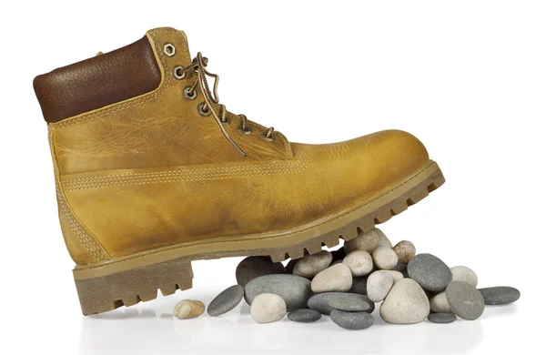 Gele laarzen op de stenen — Stockfoto