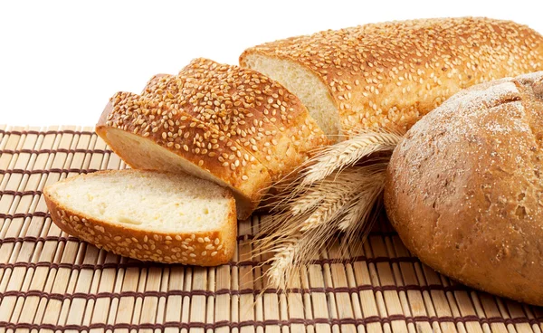 Fresh bread on a straw mat — Stock Photo, Image