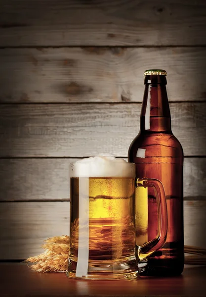 Mug of lager beer with a bottle — Stock Photo, Image