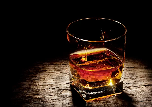 Glass of cognac in a square glass — Stock Photo, Image