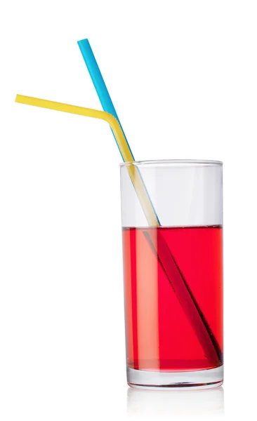 Glass of red drink and tubes — Stock Photo, Image