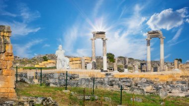 Ancient city of Hierapolis with statue of Pluto and columns in Pamukkale clipart