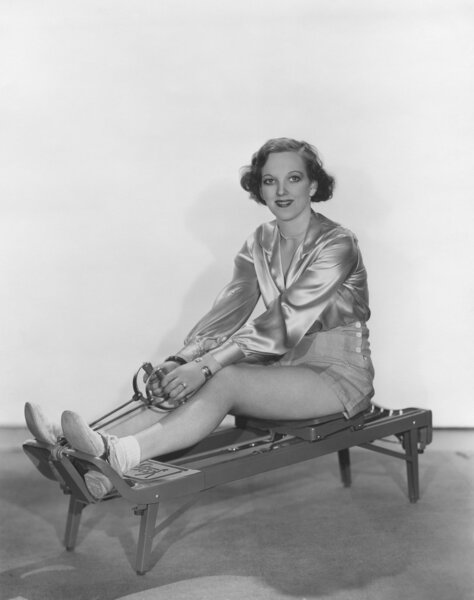 Woman posing on rowing machine