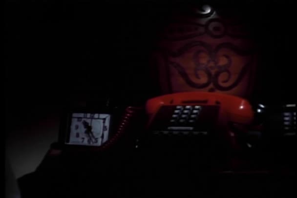 Person turning on lamp and picking up telephone receiver — Stock Video