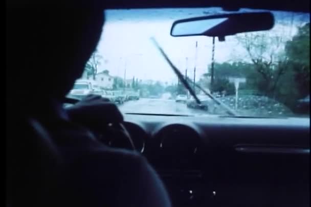 Vista interior del hombre conduciendo coche bajo la lluvia — Vídeos de Stock