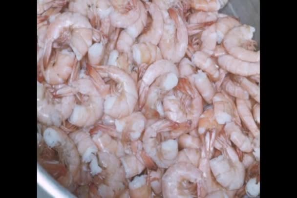 Close-up of grabbing raw shrimp from steel pan — Stock Video