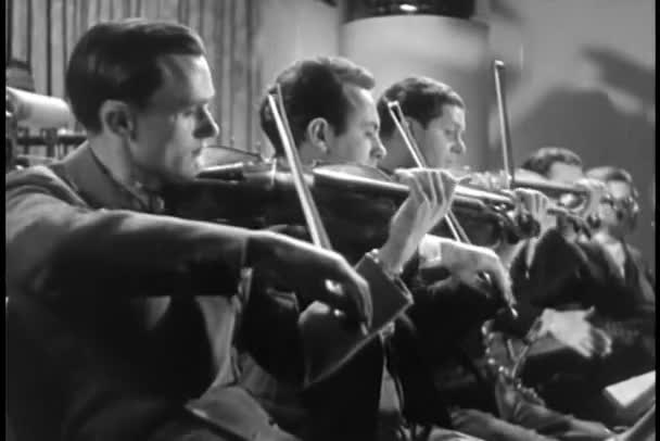 Violinists playing in orchestra — Stock Video