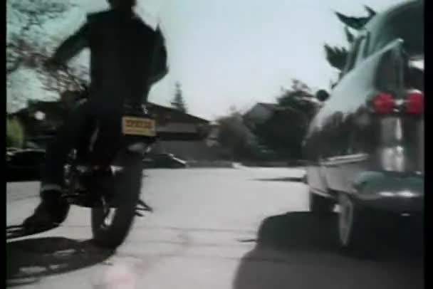 Rear view of man riding motor bike down street — Stock Video