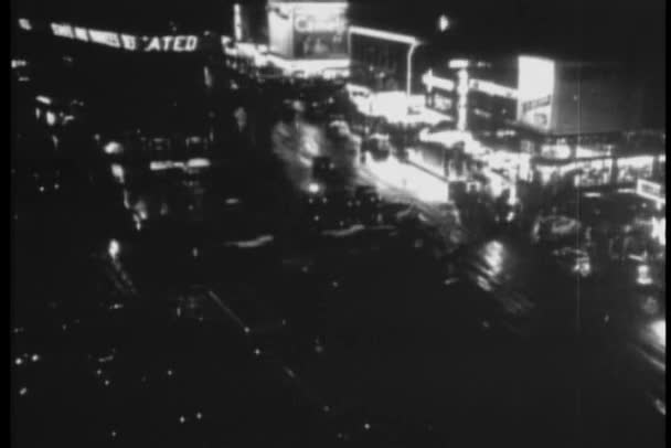 High angle view of city street and electronic news ticker at night — Stock Video