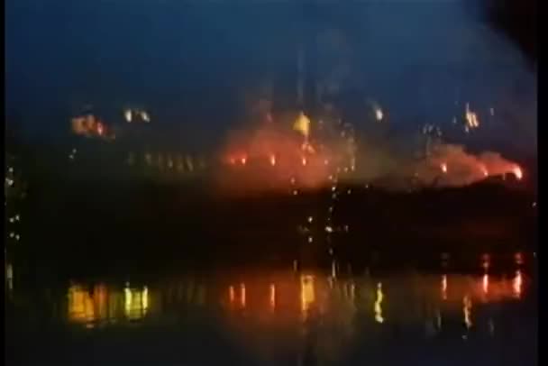 Wide shot of fireworks reflecting in river — Stock Video