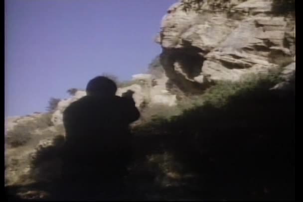 Gun melawan di lereng bukit berbatu — Stok Video