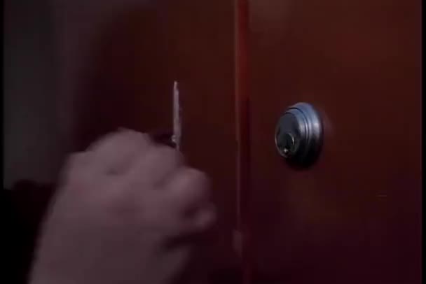 Close-up of jittery hand trying to put key in lock — Stock Video