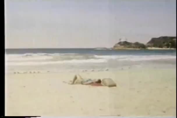 Wide shot woman tanning on beach — Stock Video