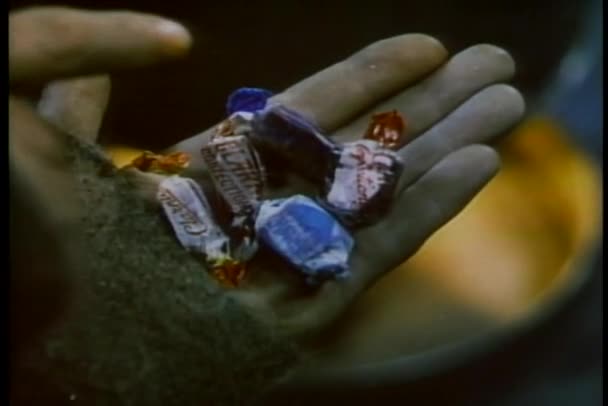 Close-up of man counting and sharing candy — Stock Video