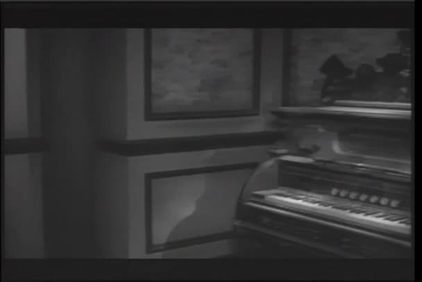 Panning to antique piano playing in haunted house — Stock Video