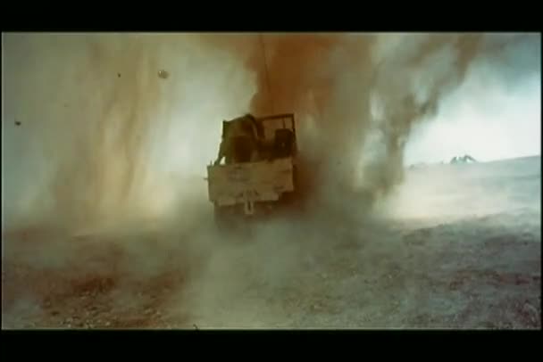 Military jeep driving into explosion — Stock Video